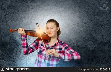 Girl with violin. Young pretty girl in casual playing violin