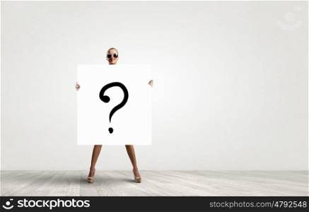 Girl with white banner. Young woman in sunglasses showing white banner with question mark