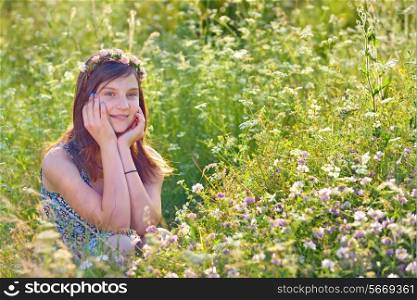 girl with wreath from flowers on field