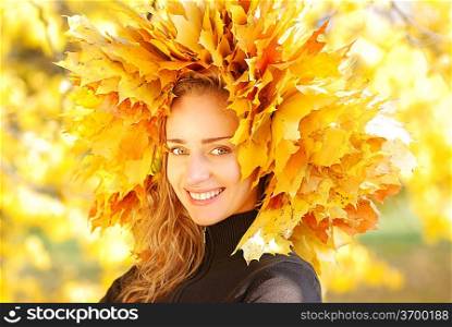 Girl with yellow autumn leaves