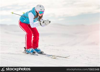 Girl woman skier in downhill position