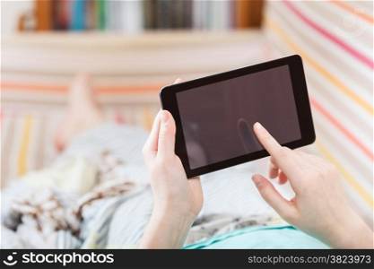 girl working with tablet pc in living room