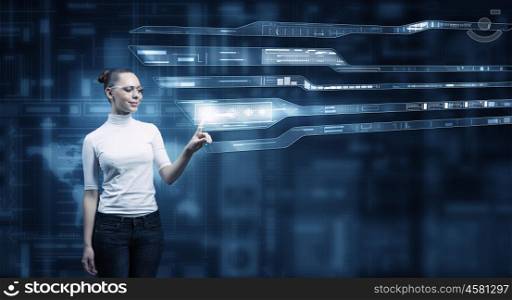 Girl working with virtual screen . Virtual holographic interface used by young pretty woman