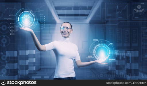 Girl working with virtual screen . Virtual holographic interface used by young pretty woman