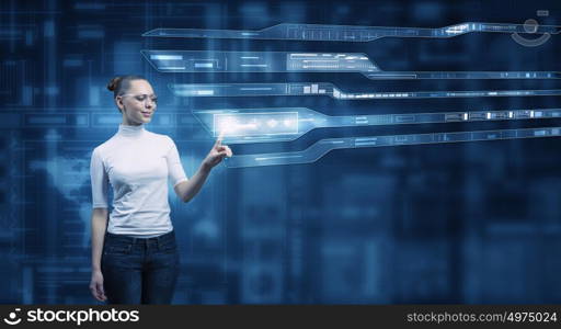 Girl working with virtual screen . Virtual holographic interface used by young pretty woman