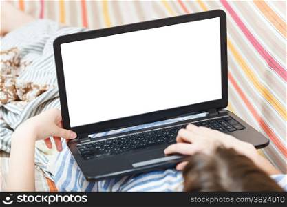 girl works on laptop with cut out screen in living room