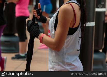 Girl Wrapping Her Hands with Yellow Hands Wraps: Fitness and Boxing Workout
