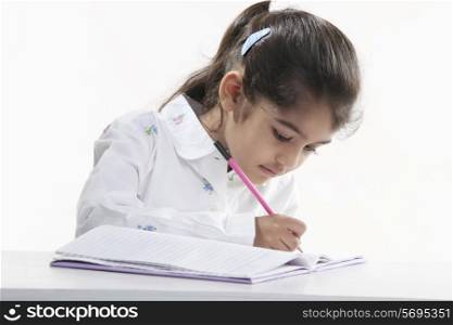 Girl writing in a notebook