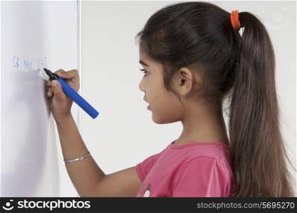 Girl writing on a board