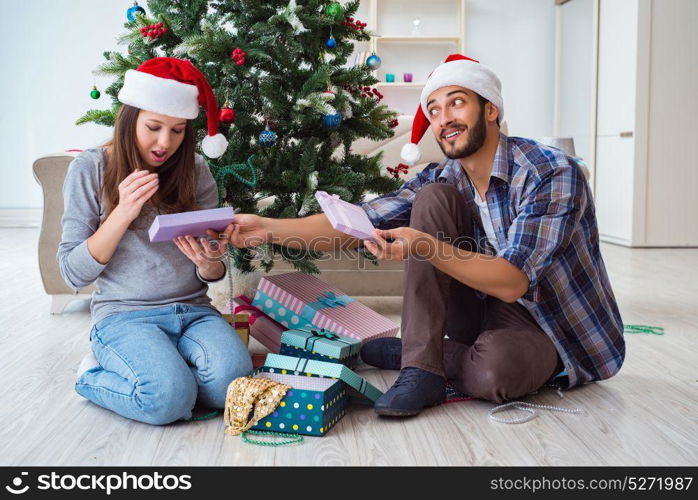 Girlfriend and boyfriend opening christmas gifts