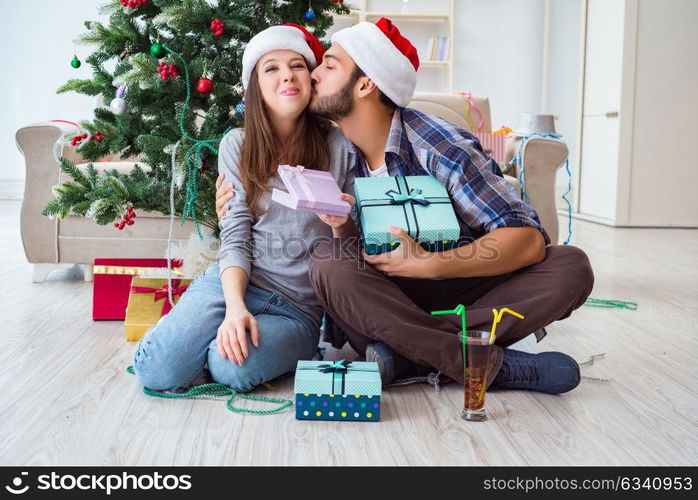 Girlfriend and boyfriend opening christmas gifts