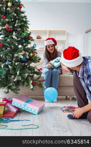 Girlfriend and boyfriend opening christmas gifts