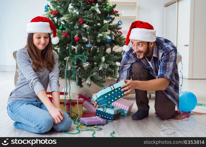 Girlfriend and boyfriend opening christmas gifts