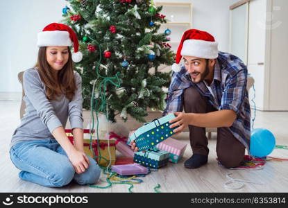 Girlfriend and boyfriend opening christmas gifts