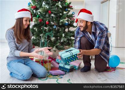 Girlfriend and boyfriend opening christmas gifts