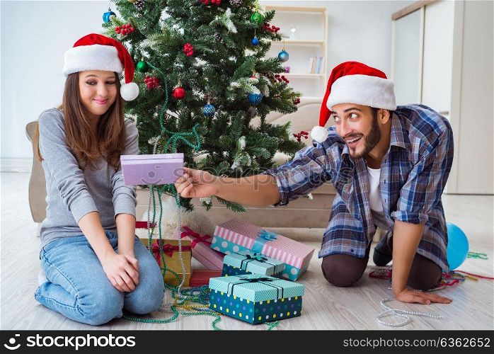 Girlfriend and boyfriend opening christmas gifts