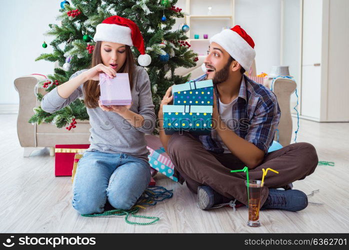 Girlfriend and boyfriend opening christmas gifts