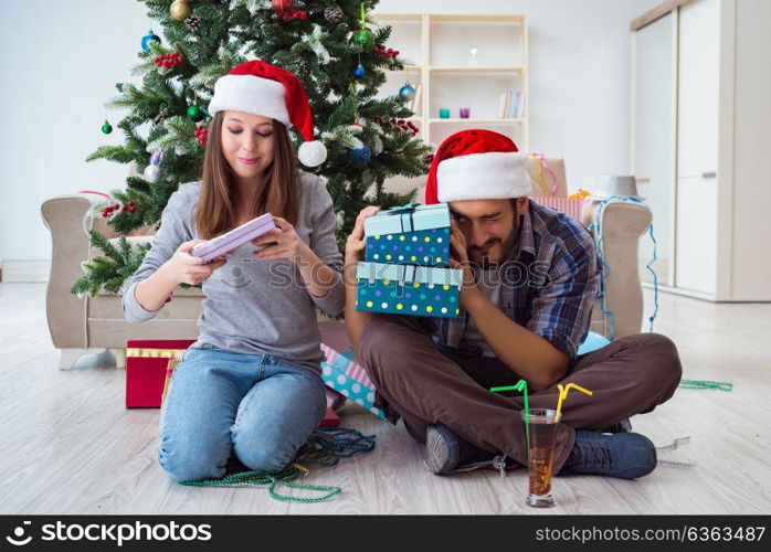 Girlfriend and boyfriend opening christmas gifts