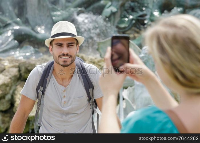 girlfriend taking a phone of her boyfriend with smartphone