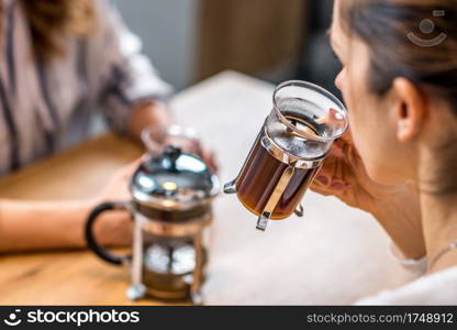 Girlfriends having coffee together in cafe or at home