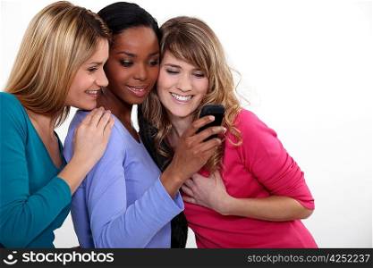 Girlfriends looking at a mobile phone