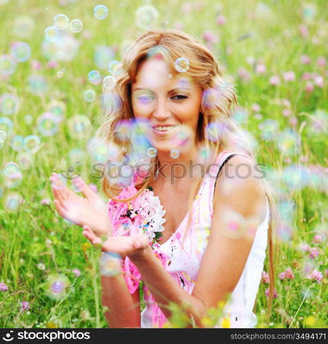 girlfriends on green grass field in soap bubbles