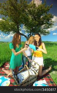 girlfriends on picnic in green grass