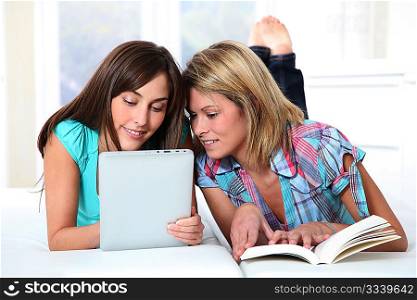 Girlfriends reading book on electronic pad