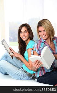 Girlfriends reading book on electronic pad