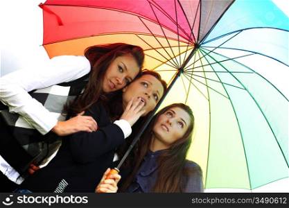 girlfriends stay under colourful umbrella