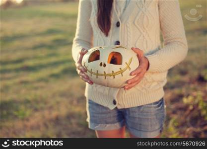 Girls arms holding pumpkin