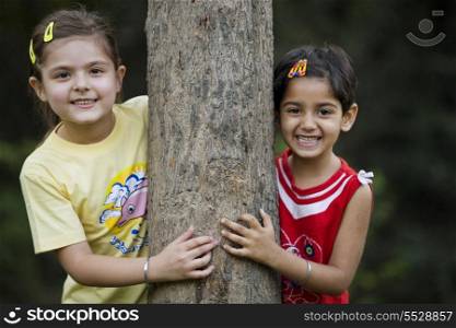 Girls behind a tree