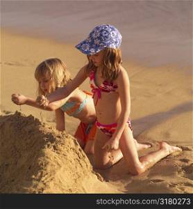 Girls building a sand castle
