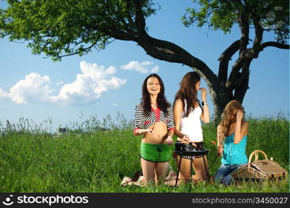 girls burn sausages on barbecue