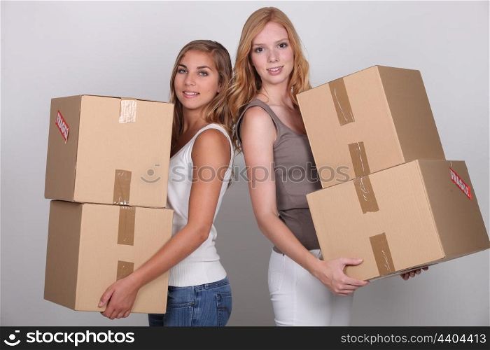 Girls carrying boxes