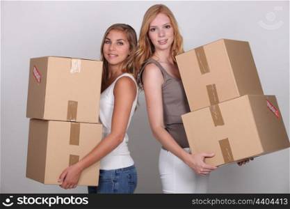 Girls carrying boxes