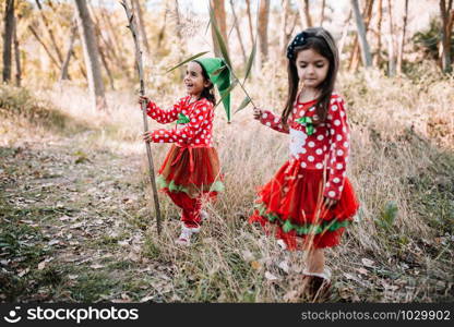 Girls disguised to christmas in the forest playing with branches