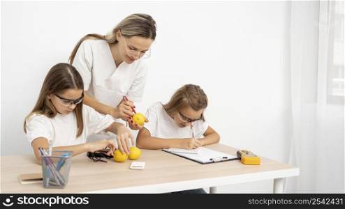 girls doing science experiments with female teacher