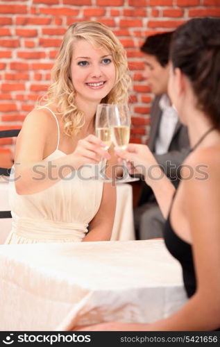 Girls drinking champagne in a restaurant