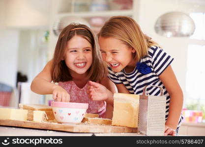 Girls Eating Ingredients Whilst Making Cheese On Toast