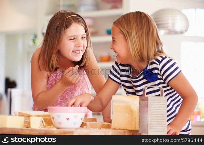 Girls Eating Ingredients Whilst Making Cheese On Toast