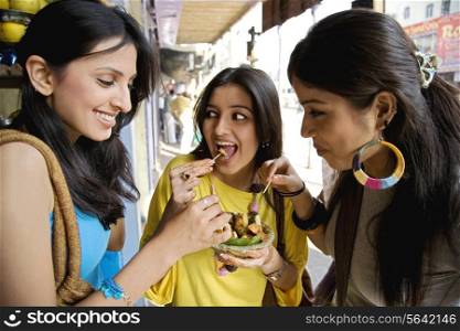Girls having fruit chaat , India