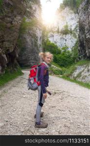 girls hiker on a path at the mountains.
