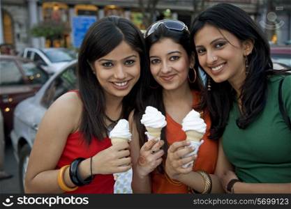 Girls holding ice-cream cones