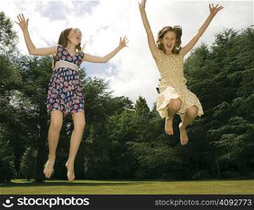 Girls jumping in garden