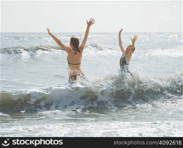 Girls jumping in the sea