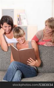 Girls laughing at book