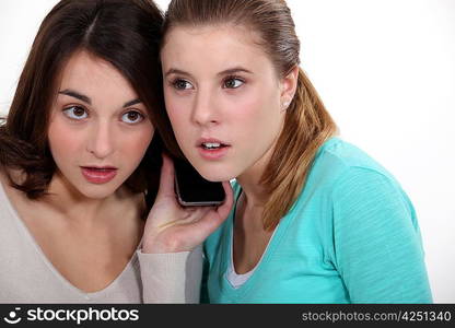 Girls listening to a cellphone