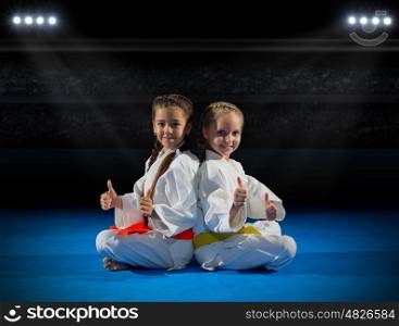 Girls martial arts fighter in sports hall