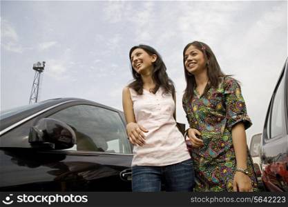 Girls next to a car